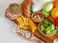 A collection of healthy food, including beans and chickpeas, spread out on a table