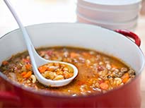 Soup made with Pulses being scooped out of a pot at a soup kitchen